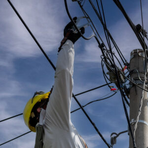 unrecognizable-person-installer-aerial-technology-cable-internet-with-security Construcción de líneas de distribución eléctrica en media y baja tensión